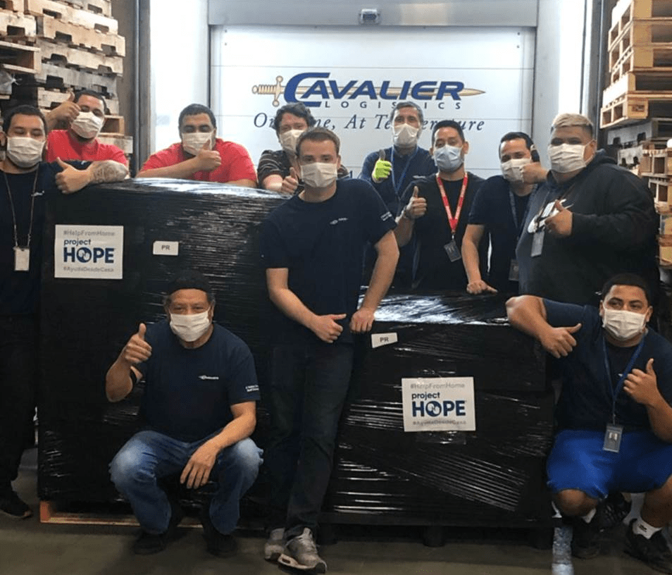 Mike Cockrill, Giovanni Araki, and the warehouse team with the Project Hope shipment. (Please Note: Social Distancing rules were briefly relaxed for the photo)