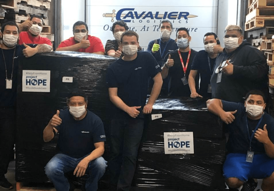 Mike Cockrill, Giovanni Araki, and the warehouse team with the Project Hope shipment. (Please Note: Social Distancing rules were briefly relaxed for the photo)